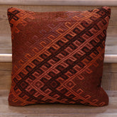 Geometric bands of decoration. Dusky pinky/red background. Decoration in orange, black, pink and violet.