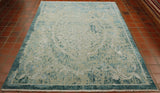Shades of light and dark turquoise are used.  The over design is in a soft ivory cream.  Some of there design has been erased to give a particular effect. 