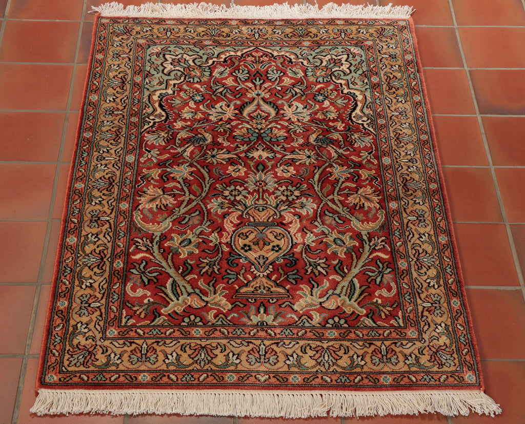 A unique, handmade and naturally dyed, Kashmir Silk rug. This piece features a terracotta ground and edging that has been combined with masterful touches of duck-egg blue, peach, and tan to create a truly eye-catching and colourful piece.