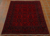 Deep red background with dark blue decoration.  Several borders, again in the dark blue.  Highlights in cream. 