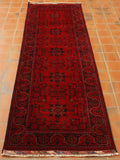 Deep red background with dark blue stylized floral decoration.  Borders of differing widths and designs.  Highlights in cream. 